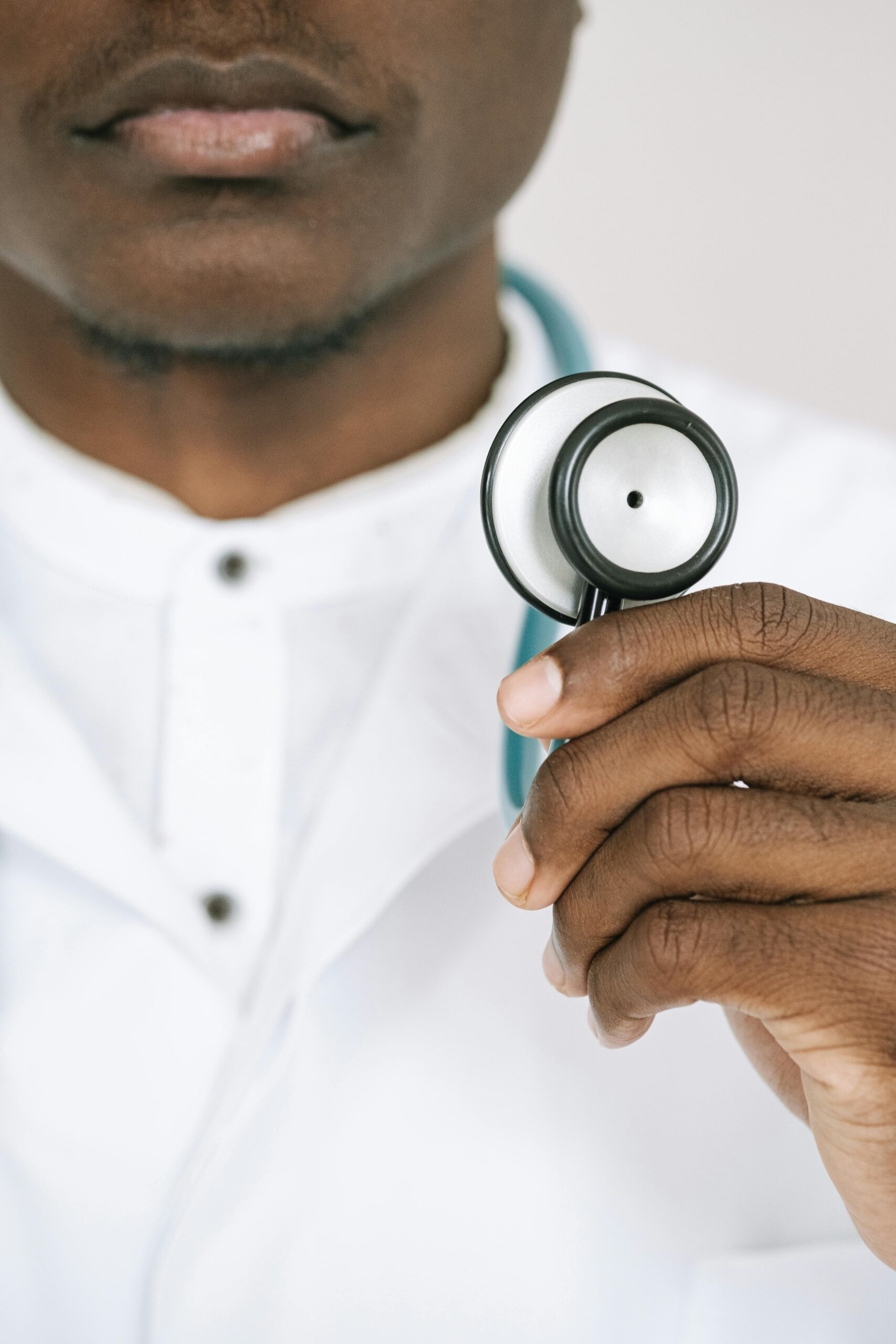 Doctor holding a stethoscope in close-up, showcasing healthcare professionalism.